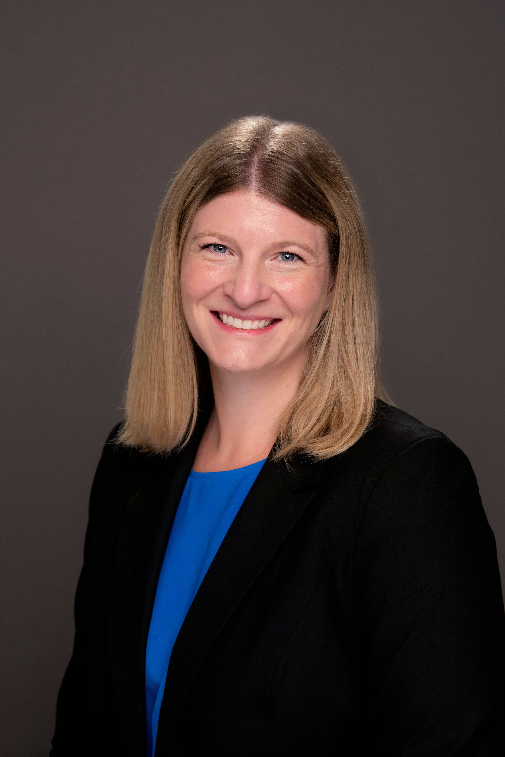 Elizabeth Brand wearing a blue shirt and black blazer
